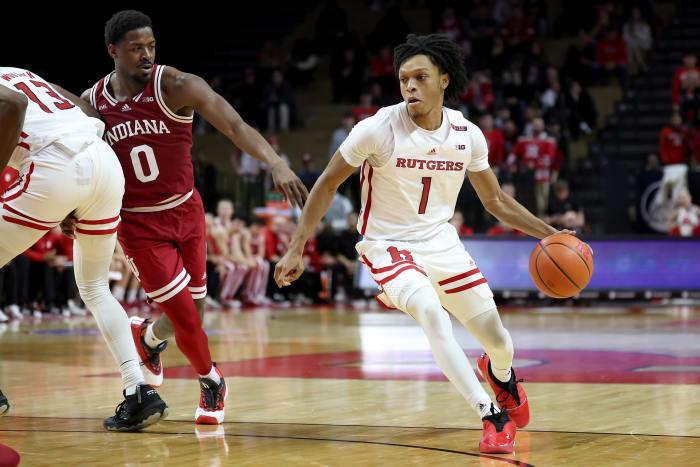 Rutgers Scarlet Knights guard Jamichael Davis (1) dribbles as Indiana Hoosiers guard Xavier Johnson (0) fouls forward Antwone Woolfolk (13) during the second half at Jersey Mike's Arena. Johnson would be ejected after an officials review.